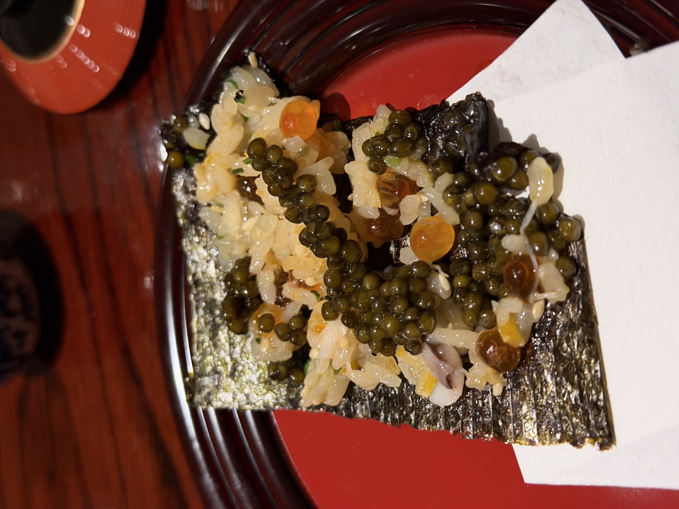 A sheet of nori topped with the crab-and-roe rice and a generous heap of caviar