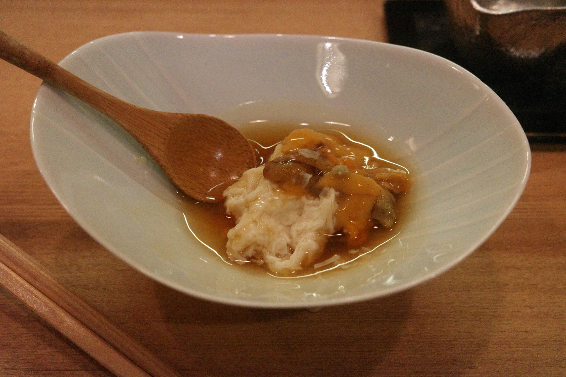 Close-up of the tofu and sea urchin in broth with mushrooms