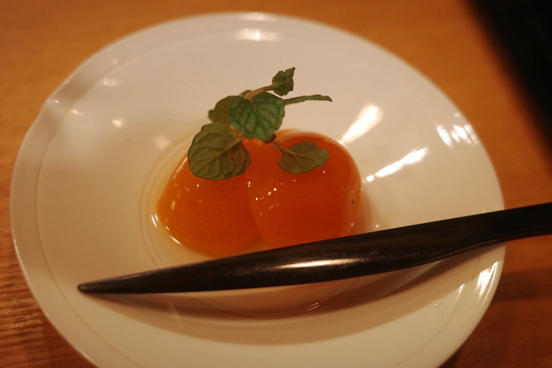 A mandarin set into jelly and served in its own skin, topped with mint